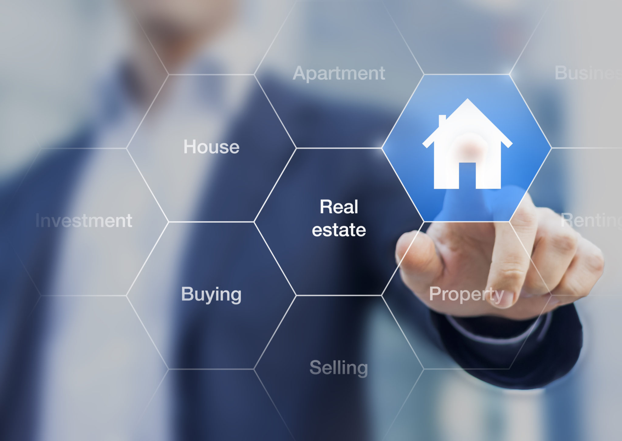 Real estate agent pushing a button with a symbol of house on a transparent screen